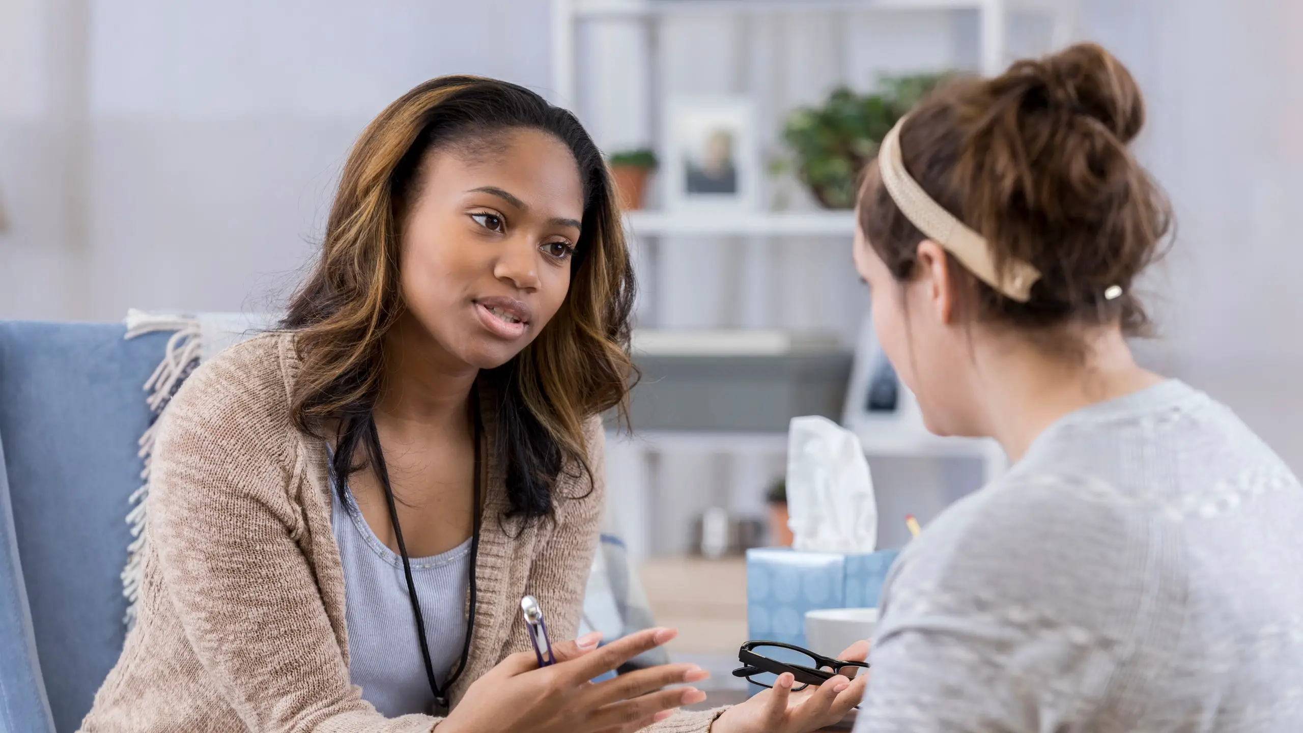 Professional counselling session between two women in a supportive office setting